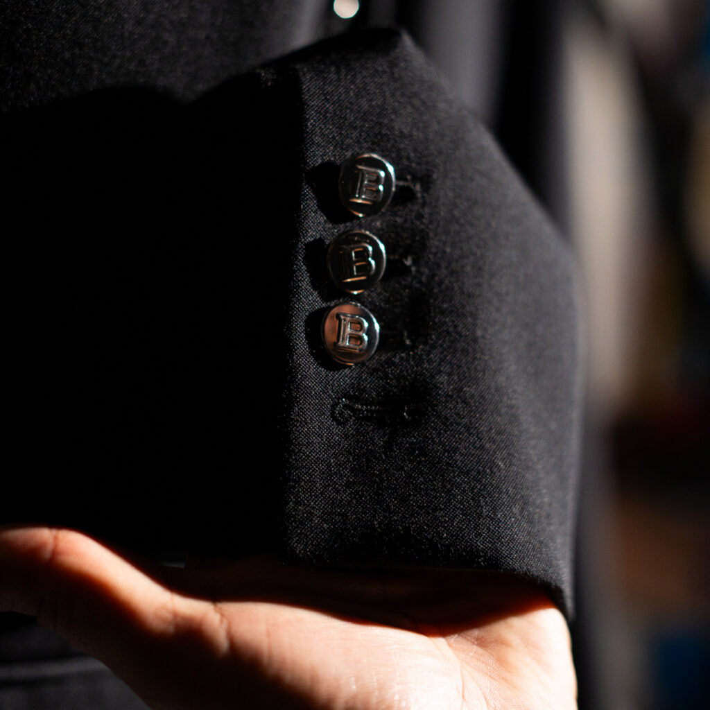 Close-up of Balmain blazer cuff with signature metal buttons