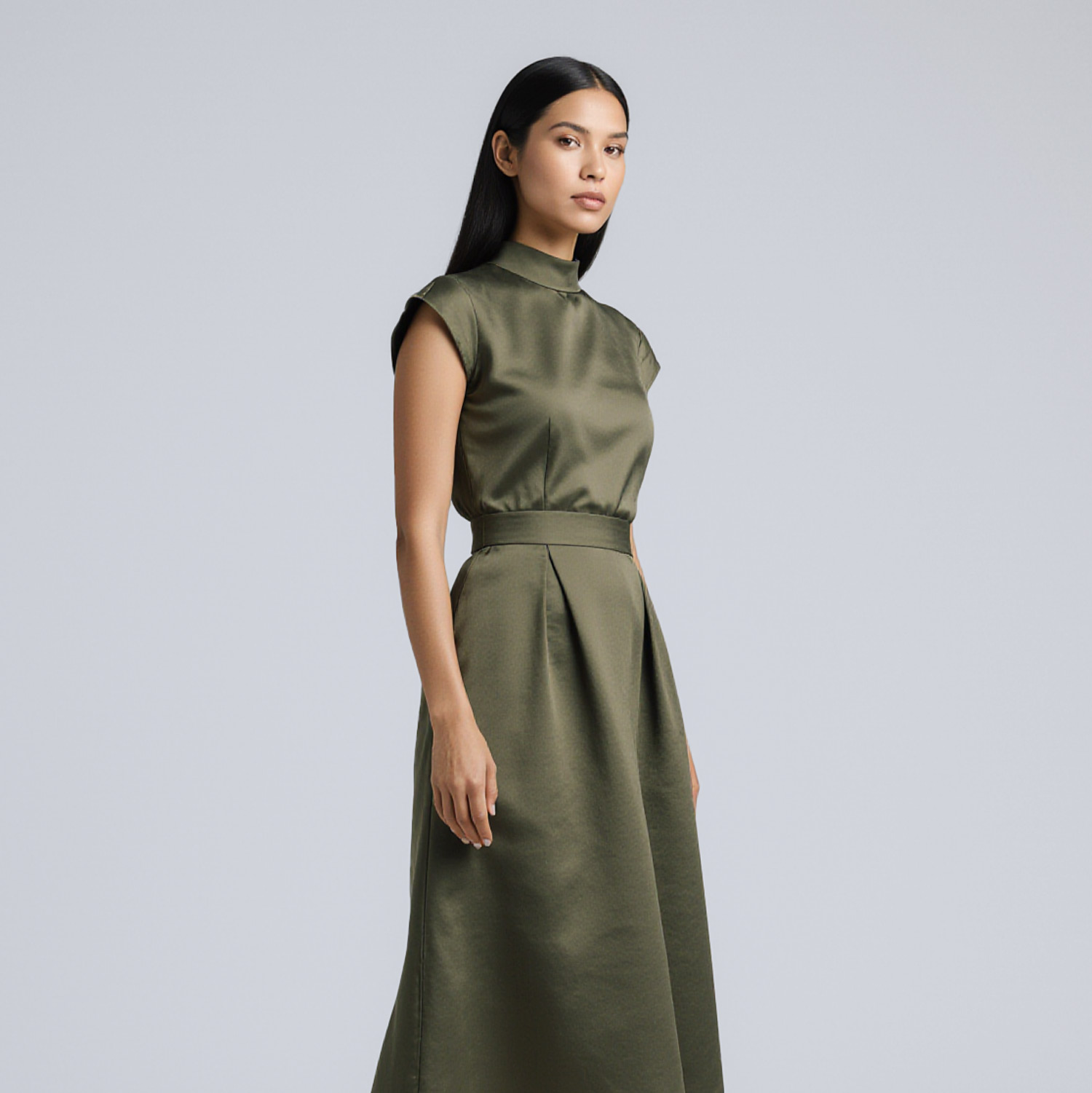 Woman wearing structured olive dress near Pinecrest